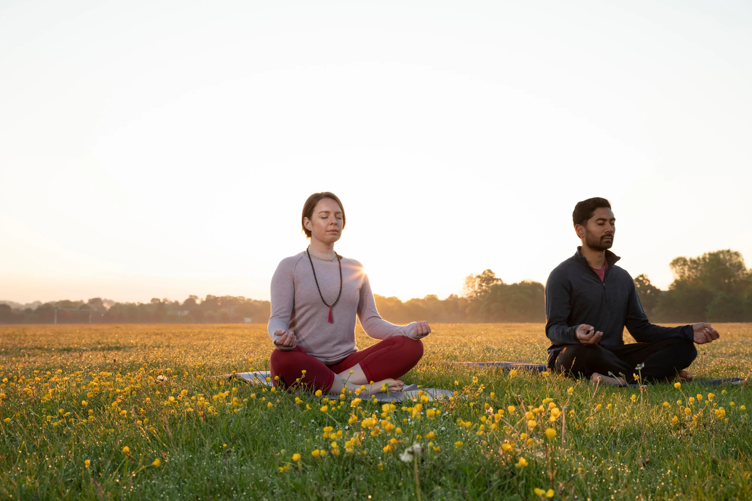 man-woman-doing-yoga-together-outdoors